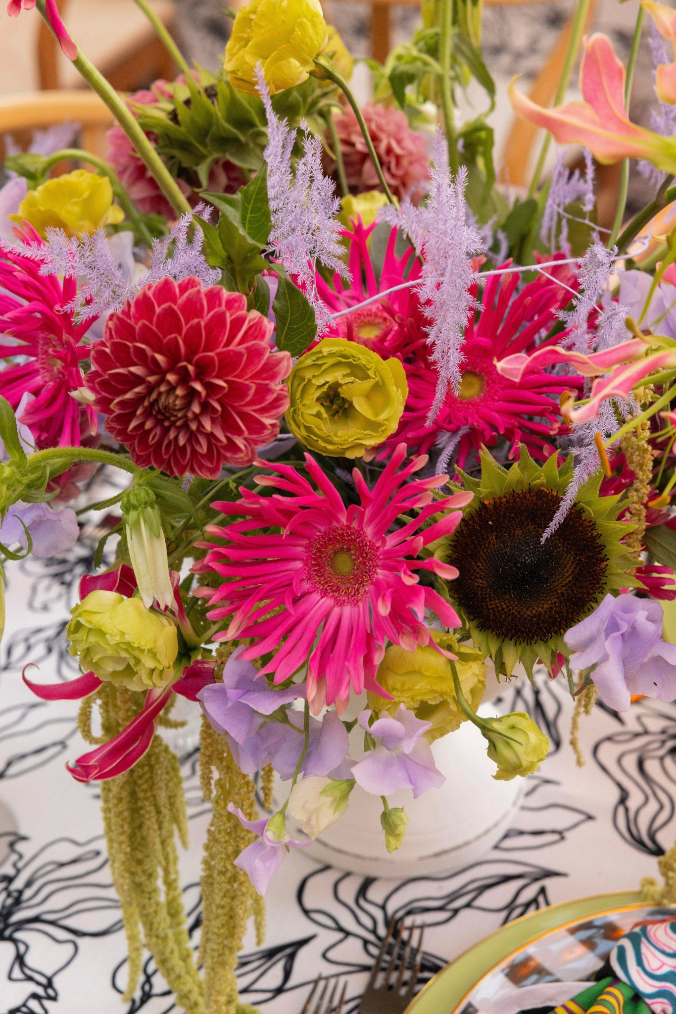 Colorful bouquet of flowers with a patterned tablecloth in the background